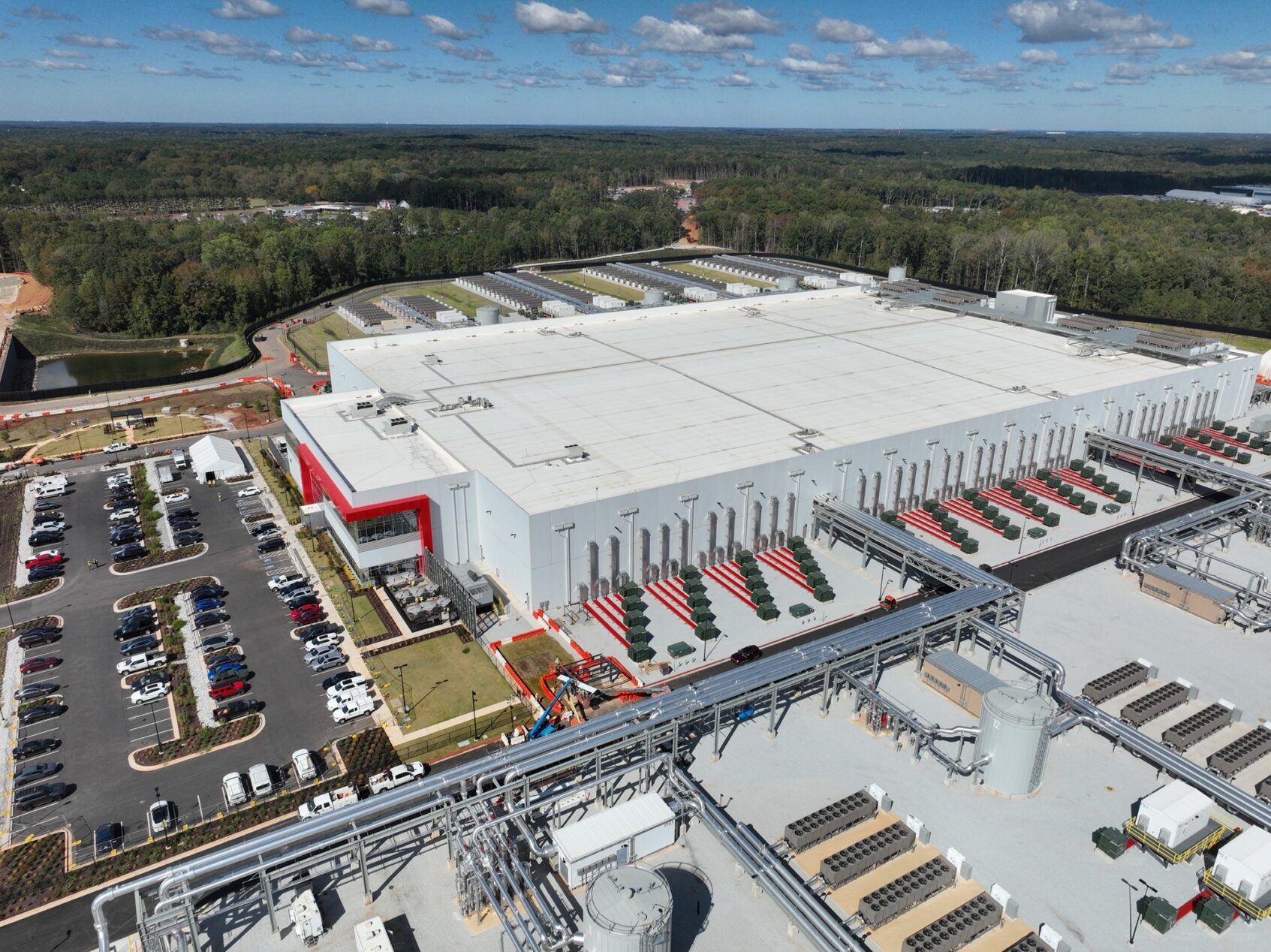 Aerial view of a modern AI data center facility showing the massive scale of infrastructure required for AI computing